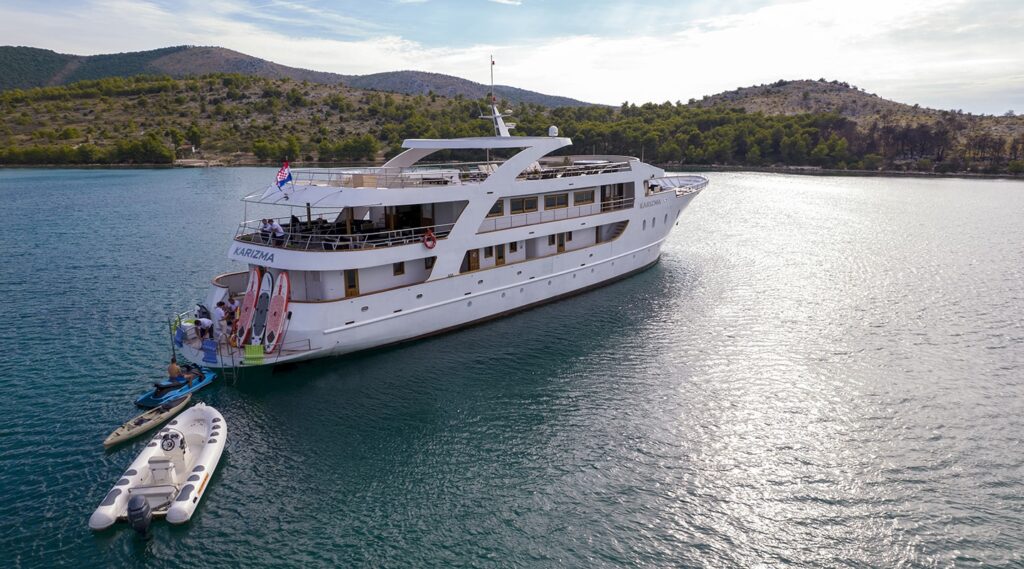 karizma yacht charter at anchor with guests