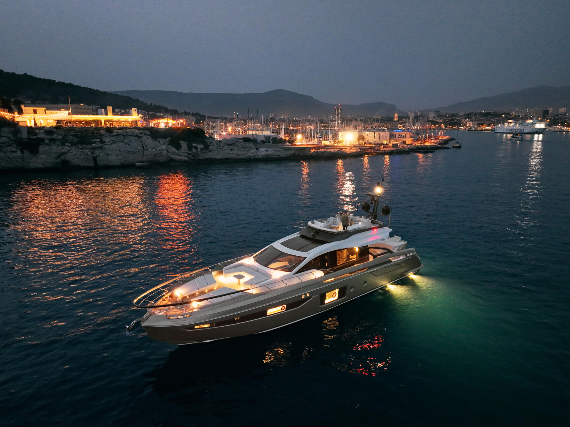 myne yacht charter port side at night